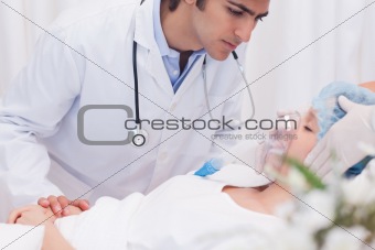 Doctor examining intensive care patient