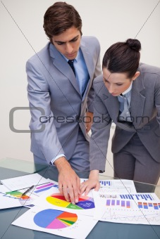 Consultant and customer looking at statistics