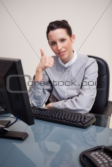 Businesswoman giving thumb up