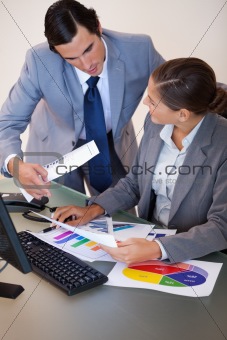 Businesswoman talking with her colleague about statistics
