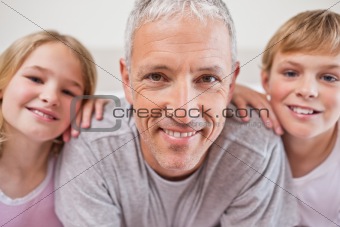 Close up of siblings and their father posing