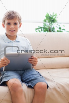 Portrait of a cute boy using tablet computer