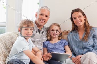 Smiling family using a tablet computer