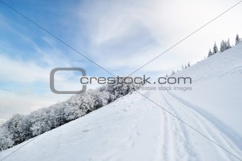 Winter road running onto hill top