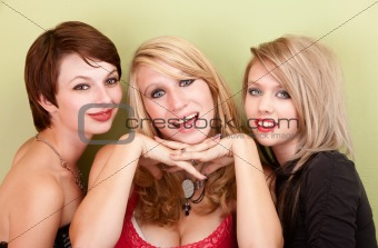 Three attractive teen girls smile for a portrait