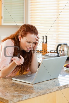 Woman looking annoyed at her laptop