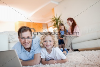 Father and son using the internet in the living room