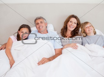 Happy family about to take a nap