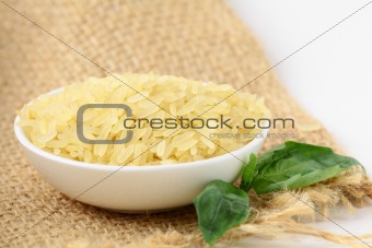 Uncooked rice in white bowl