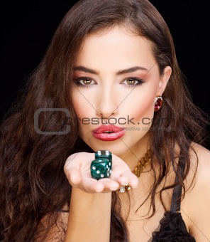woman holding dices on black background