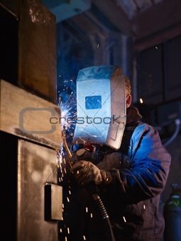 Man at work as welder in heavy industry