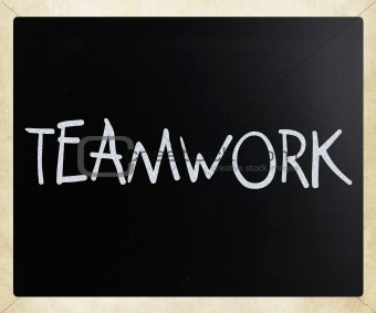 The word "Teamwork" handwritten with white chalk on a blackboard