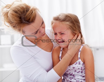 Mother comforting her crying little girl