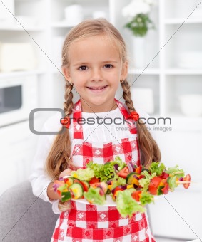 Happy girl with vegetables plate