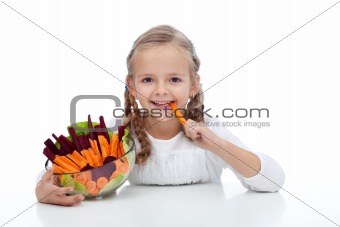 Little girl munching on a carrot stick