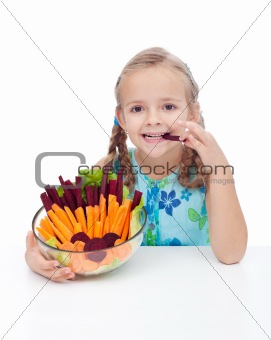 Little girl holding bowl of vegetables