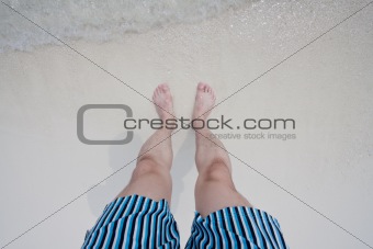 Feet on a seaside beach