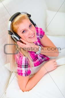 Happy girl listening music
