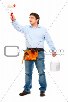 Construction worker with bucket and brush painting
