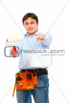 Construction worker stretching paint bucket and brush
