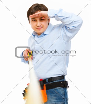 Construction worker looking into the distance on ruler 
