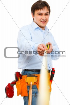 Construction worker holding ruler that going into the distance 
