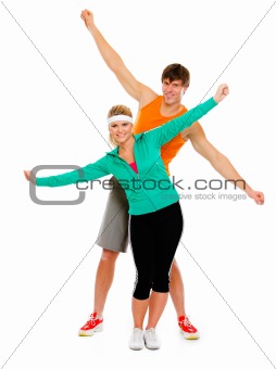 Fit girl and man in sportswear having fun isolated on white
