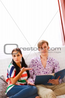 Girl showing dissatisfaction with what she saw in the photo album 
