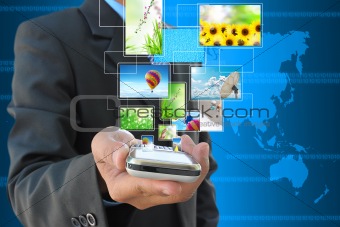 businessman hand holding mobile phone and streaming images virtual buttons