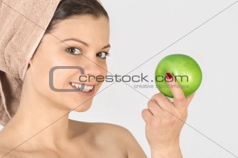 Beautiful young woman with an apple.
