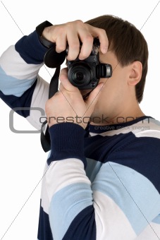 Young man with a digital camera. Isolated on white