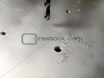 drilling holes in the metallic board