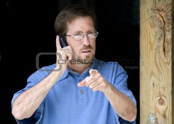 Business Man Pointing while on Phone