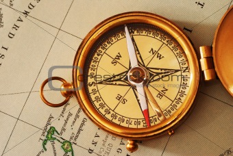Antique brass compass over old Canadian map