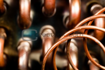Close up of orange wires and pipes