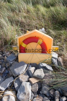 beach lifebuoy buried in the stones