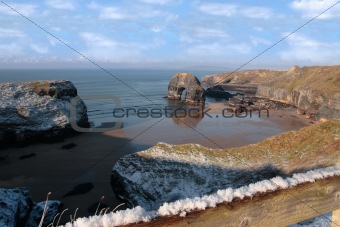 snowcovered coast beach and virgin rock