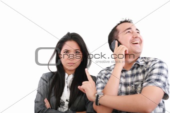 Impatient woman standing with arms crossed looking at his boyfri