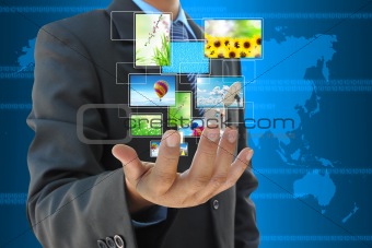 businessman hand holding streaming images virtual buttons