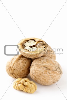 whole and chopped walnuts on the white background