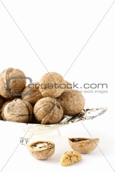 whole and chopped walnuts on the white background