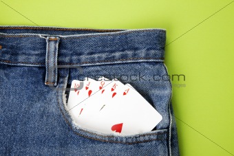 Royal flush with playing cards in blue jeans pocket 