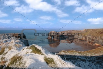 frozen snowcovered coastal beach view and virgin rock