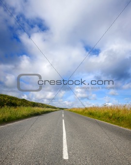 An empty English countryside road and a big sky in Cornwall.