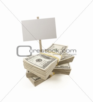 Stacks of One Hundred Dollar Bills with Blank Sign Isolated on a White Background.