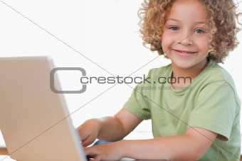 Smiling boy using a notebook