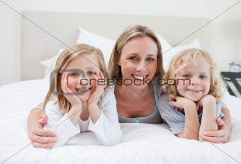 Mother embracing her children