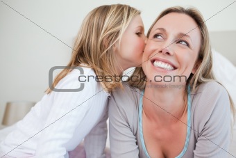 Girl giving her mother a kiss
