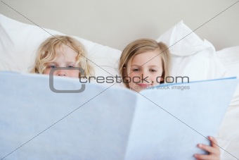 Siblings reading bedtime story
