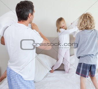 Playful family having a pillow fight
